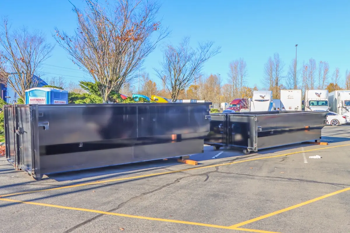 Professional dumpster rental service with roll-off container on residential driveway in Champlin